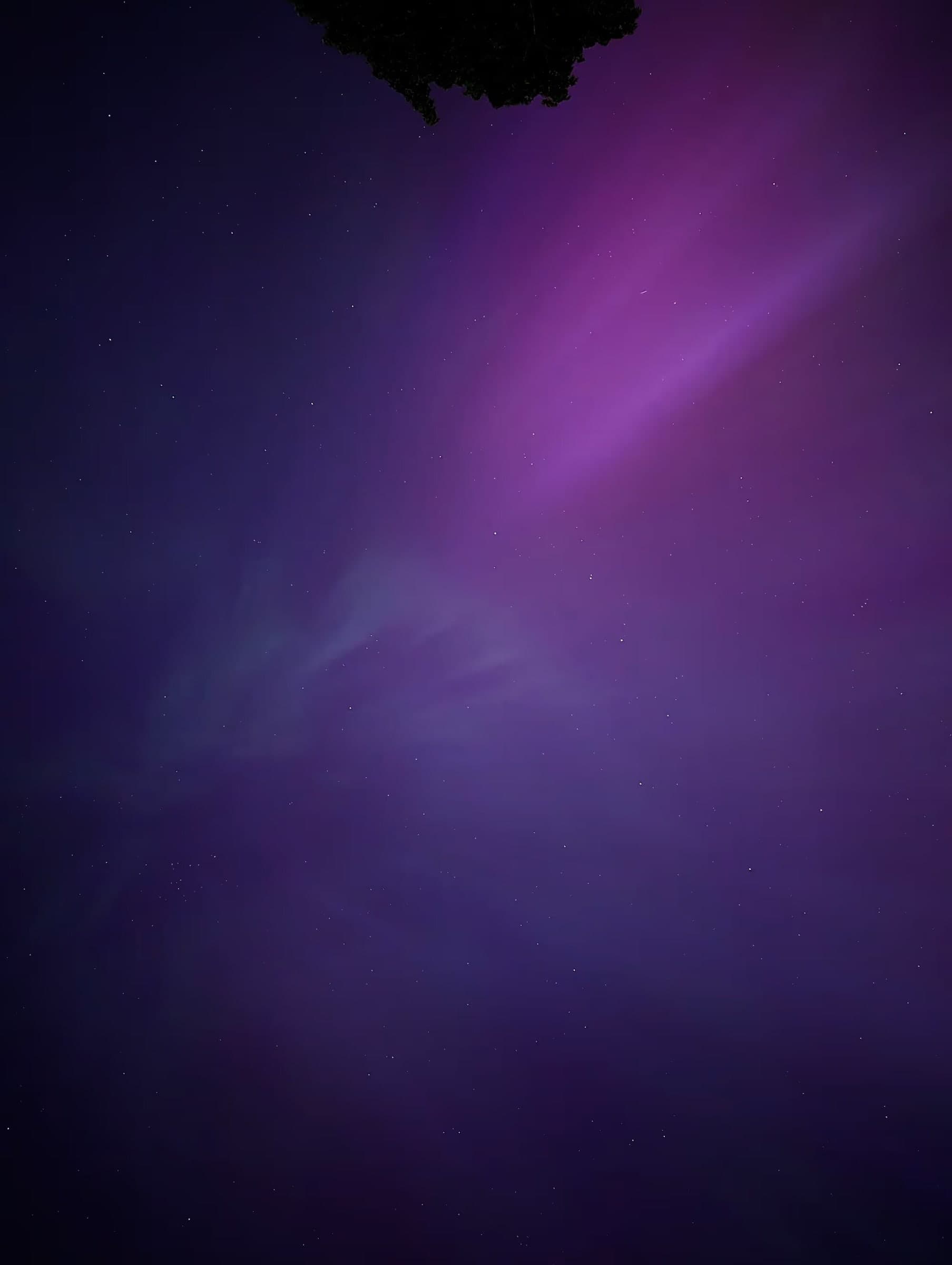 The northern lights turning the night sky purple
